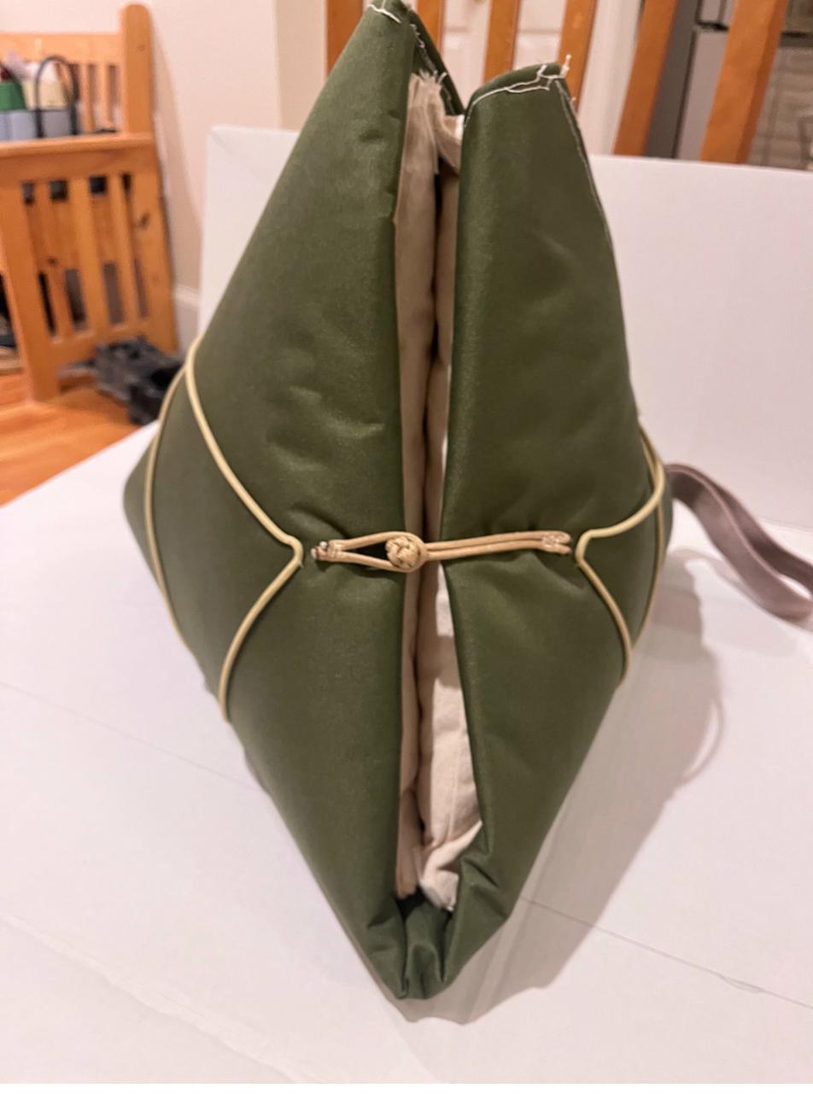 The bundle opening to reveal the cream pillow core inside.